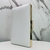 Clutch quadrada off white lisa, com detalhes em dourado na internet